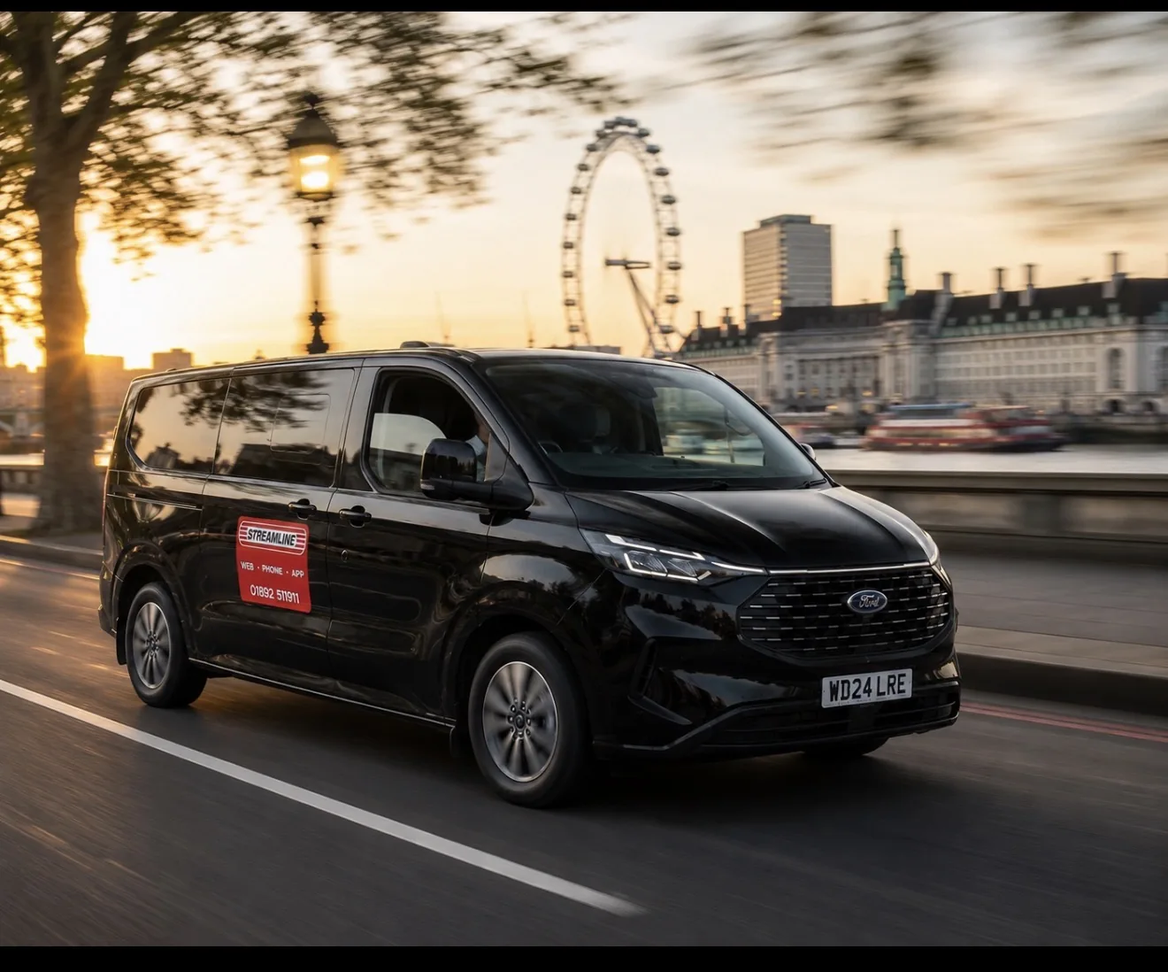 Streamline courier van passing the London Eye at dusk
